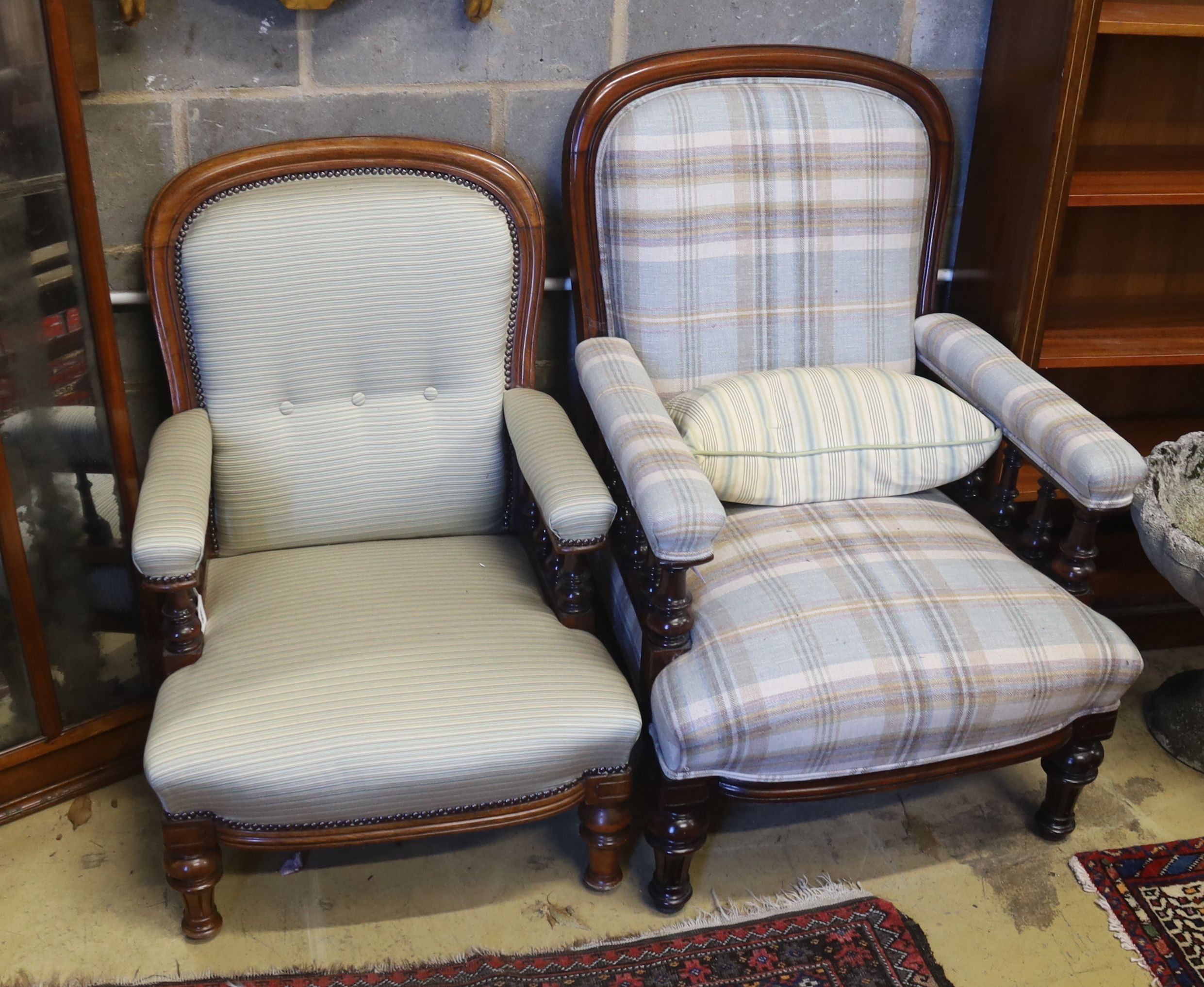 A pair of Victorian mahogany upholstered spoon back armchairs, larger width 68cm, depth 80cm, height 92cm